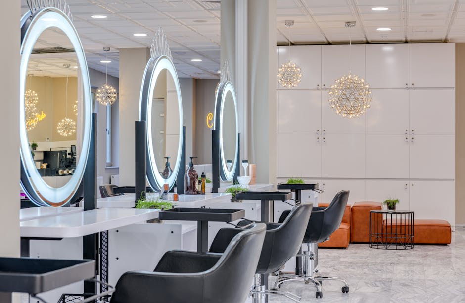 Bright and elegant hair salon interior featuring modern lighting and round mirrors for a chic and relaxing atmosphere.