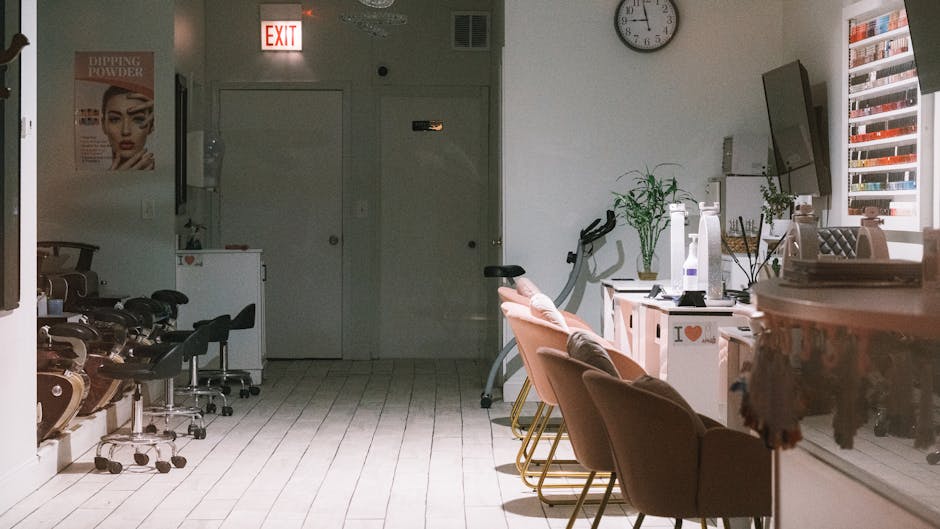 A cozy and modern nail salon interior featuring stylish chairs and nail polish display.