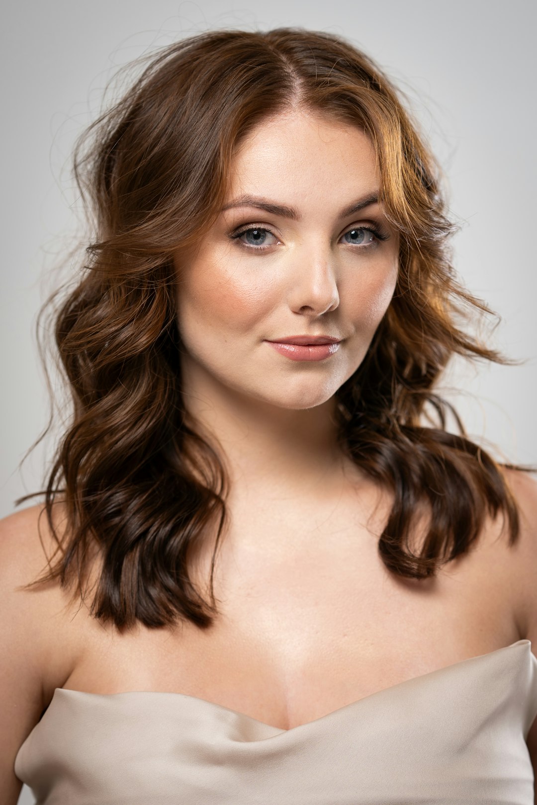 a woman in a strapless dress posing for a picture