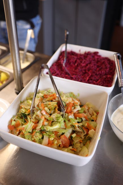 A vibrant salad bar featuring fresh lettuce and beet salad in a buffet setting.