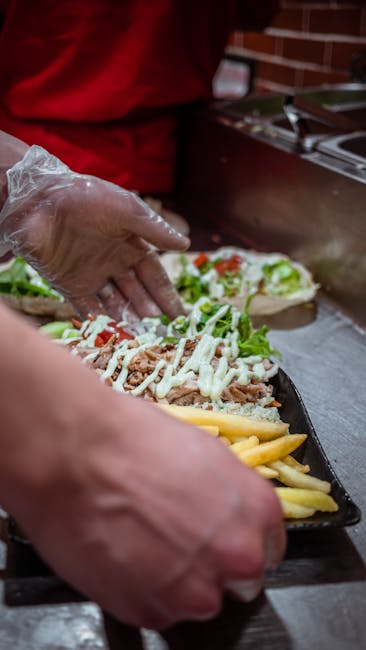 Delicious Moroccan street food being prepared with fries and toppings in Fes.