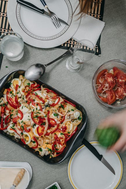 A vibrant vegetable casserole with peppers and cheese served on a dining table. Ready to eat meal.