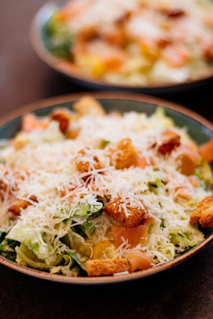 A mouth-watering Caesar salad topped with shredded cheese and golden croutons.