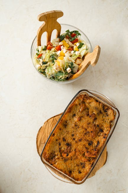 Delicious gourmet baked dish paired with a refreshing salad, captured from above.