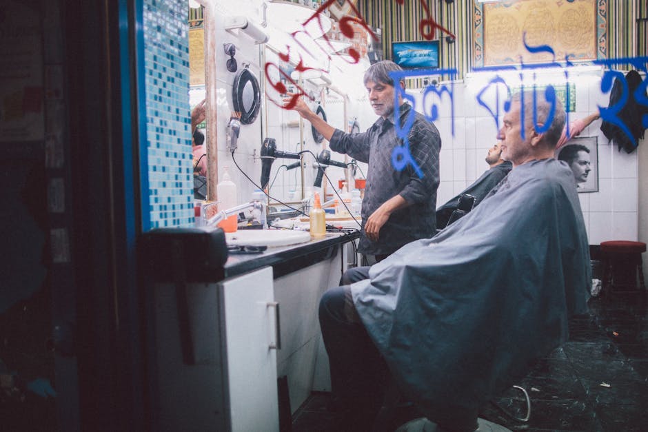 A candid view of a traditional barbershop in London, showcasing a stylist at work.