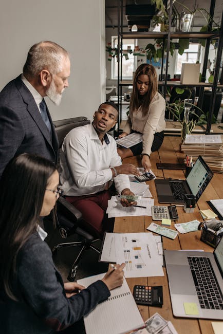 A diverse group of professionals engaging in a collaborative effort in the office.