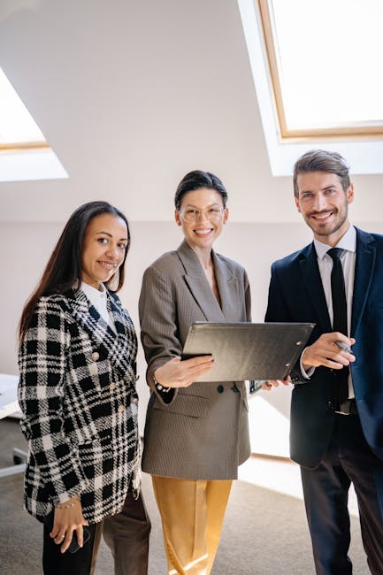 Professional business team smiling together in an office environment.
