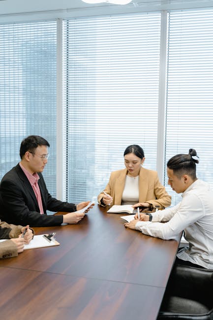 Business professionals having a meeting in a contemporary office, focused on teamwork.
