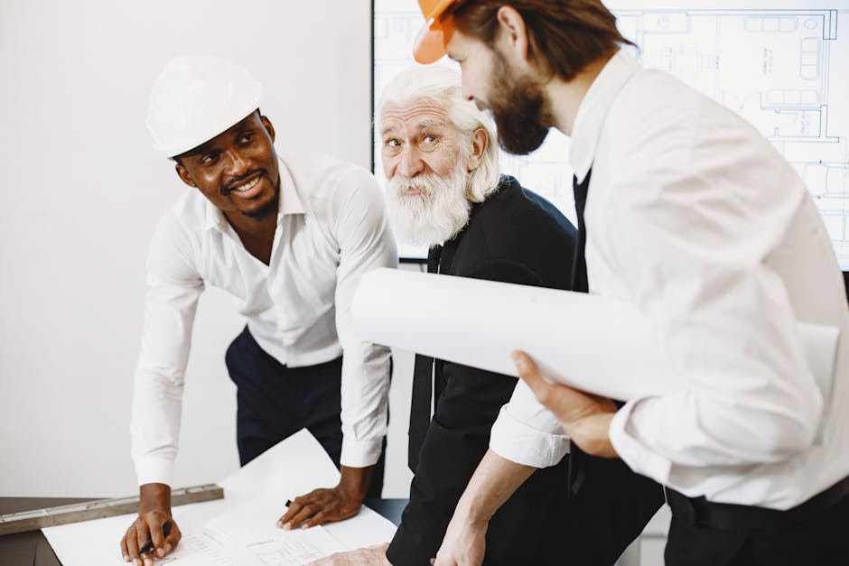 Engineers and architects working together on a construction plan, demonstrating teamwork and professionalism.