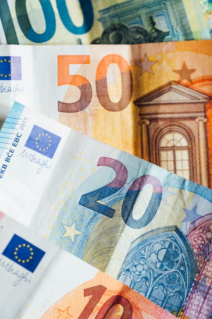 Close-up of various denominations of Euro banknotes, showcasing European currency details.