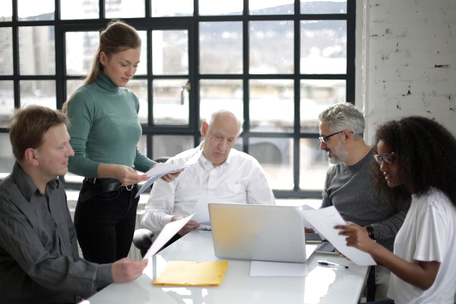 Group of professionals collaborating in a bright, modern office setting.