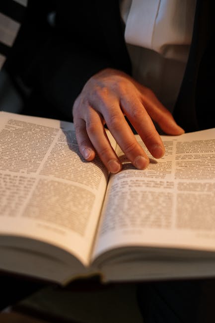 Close-up of an Orthodox Jewish man reading a Hebrew Torah during Shabbat.