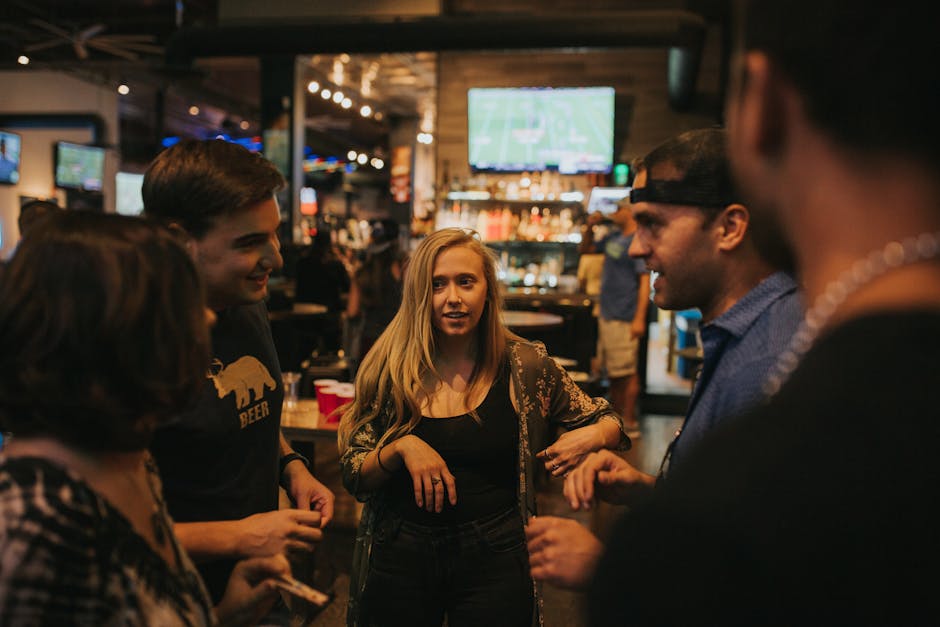 Group of friends enjoying a night out at a bar in Denver, sharing laughs and conversation.