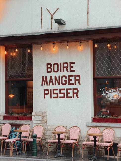 Quaint European café with iconic French text on the wall and outdoor seating.