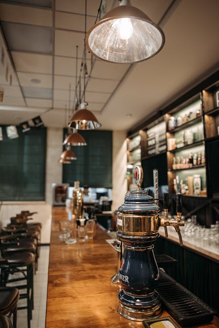 Inviting bar with a rustic vibe featuring a draft beer tap under soft lighting. Perfect for a casual evening.
