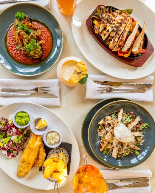 A vibrant collection of plated dishes showcasing diverse cuisine in a restaurant setting.