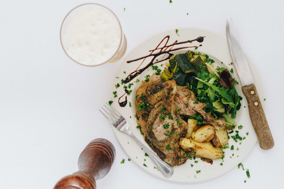 Delicious lamb roast with vegetables and beer pairing, perfect for a gourmet dinner setting.