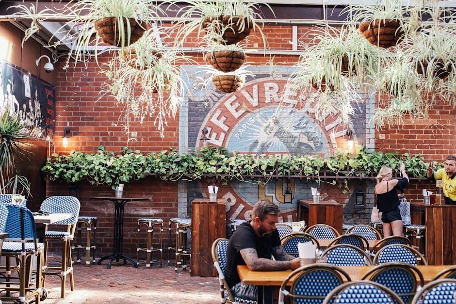 Urban restaurant with hanging plants and vibrant atmosphere.