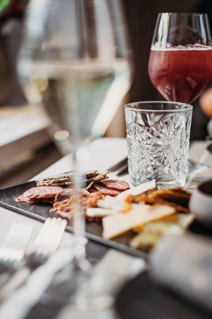 Elegant table setting featuring assorted gourmet appetizers and wine for an indulgent aperitif.