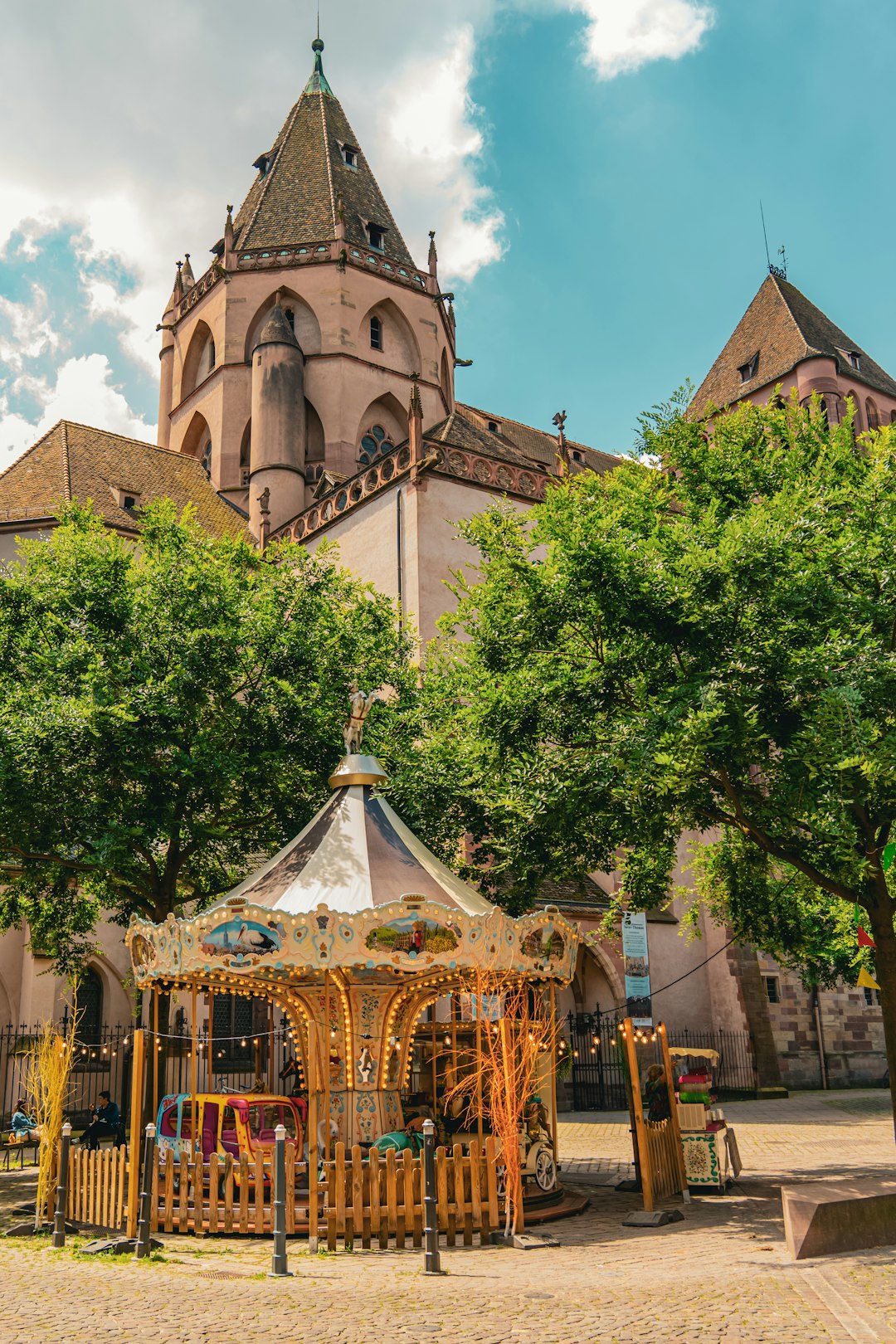 A large building with a clock tower next to trees