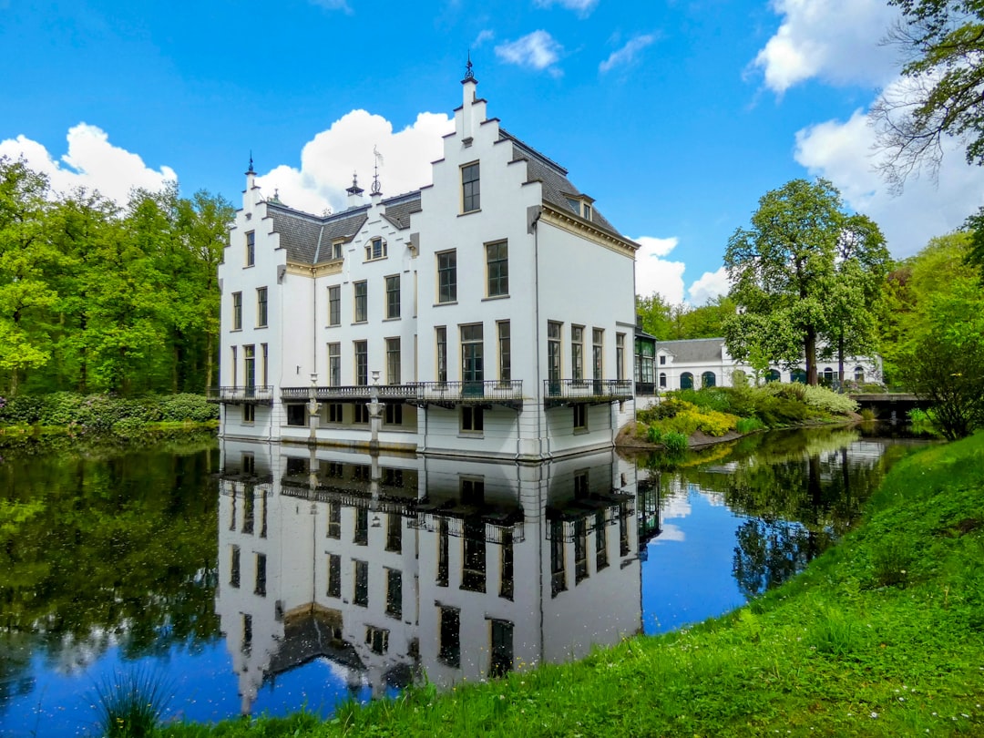 a large white building sitting next to a river