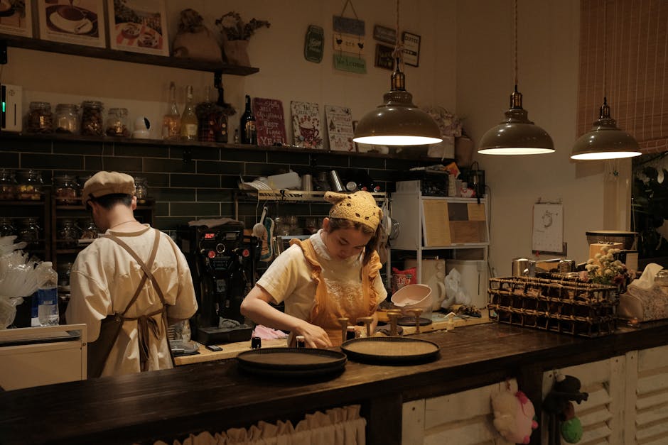 Vintage-style cafe in Bến Tre, Vietnam with baristas preparing coffee. Warm, inviting atmosphere.