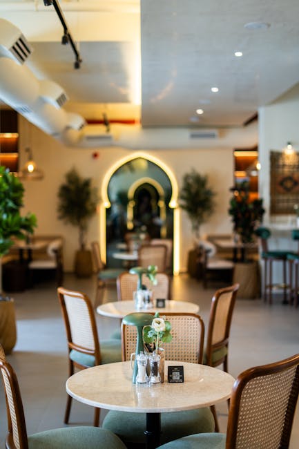 Stylish cafe interior in Dubai featuring elegant arch design and ambient lighting for a cozy dining experience.
