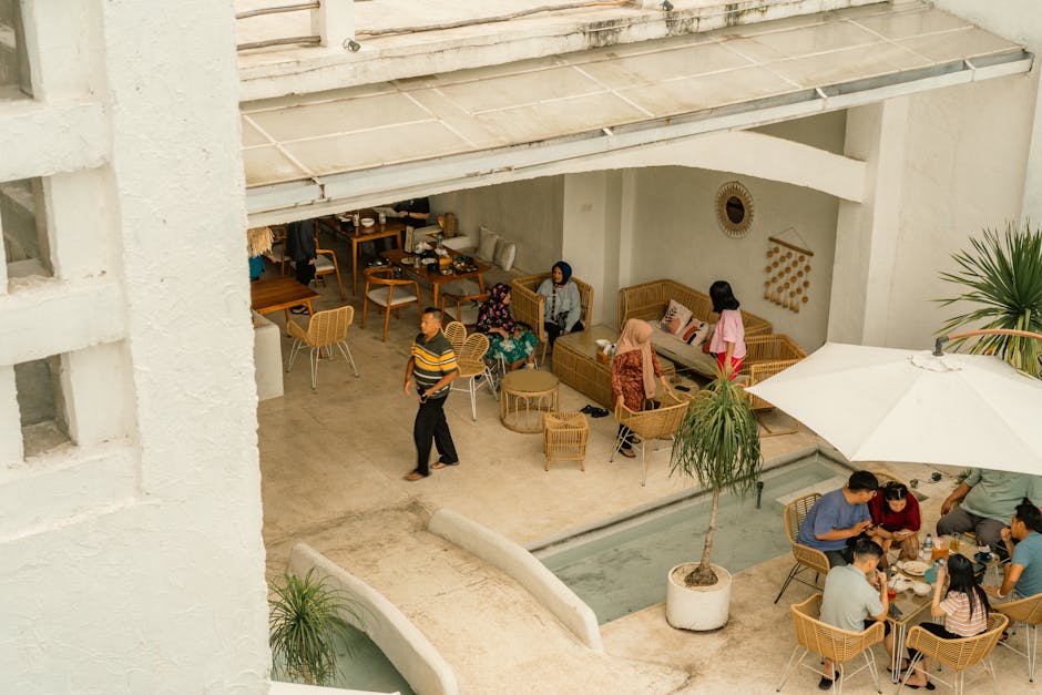 A lively scene at an outdoor cafe in Surabaya, Indonesia, showcasing people enjoying a relaxed dining experience.