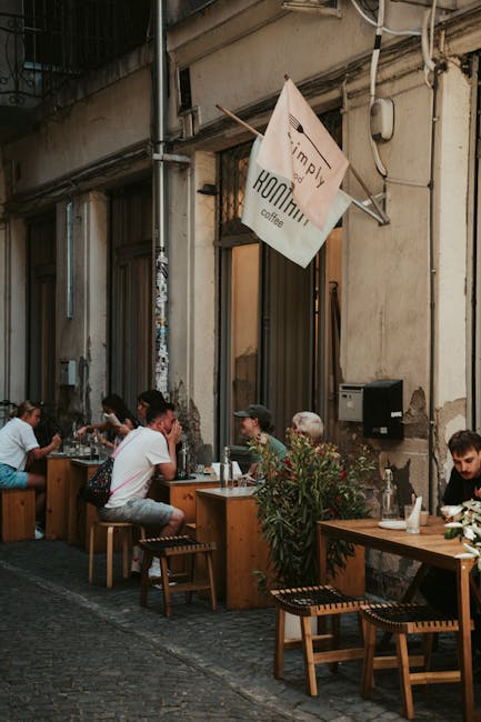 People dining at an outdoor café in Budapest, Hungary. Cozy street setting with a warm atmosphere.