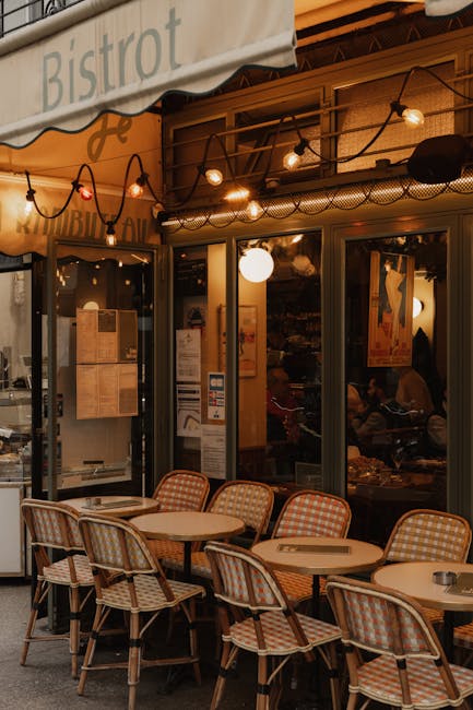 Paris bistro with outdoor seating, warm string lights, and cozy ambiance in the evening.