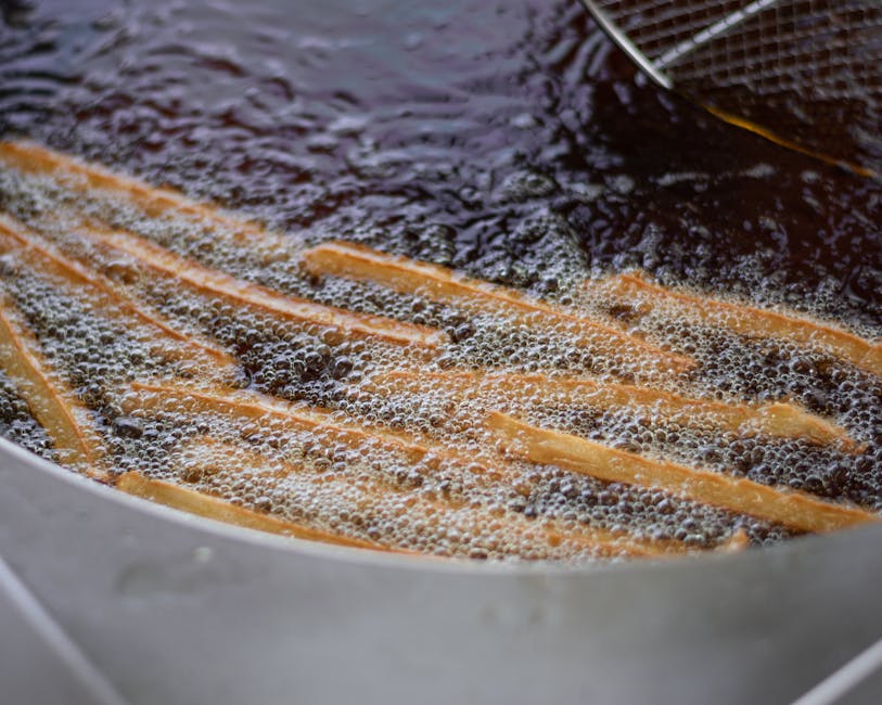 Close-up of French fries being deep-fried in hot oil. Perfect for food enthusiasts.
