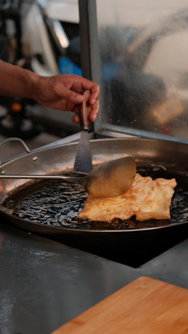 Hand cooking a traditional Chinese pastry in a large pan, Yunnan cuisine.