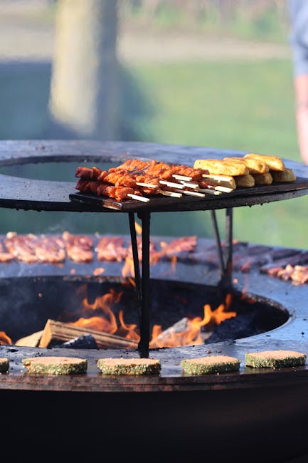 Delicious barbecue skewers sizzling over an open flame grill outdoors. Perfect for summer gatherings.