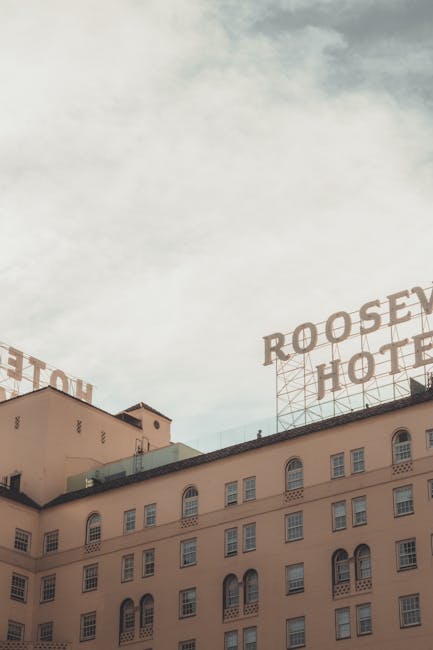 View of the iconic Roosevelt Hotel with classic architecture under a cloudy sky.