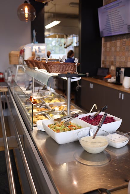 Salad bar with diverse dishes in a modern cafeteria. Ideal for restaurant visuals.