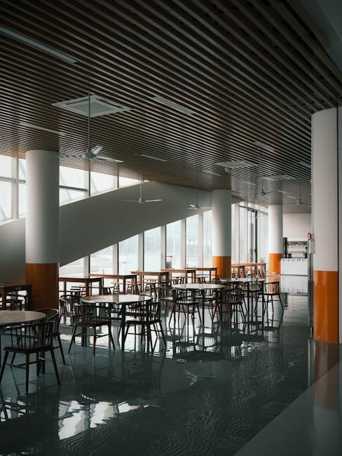 Spacious modern cafeteria with wooden slat ceilings and large windows. Ideal for architectural designs.