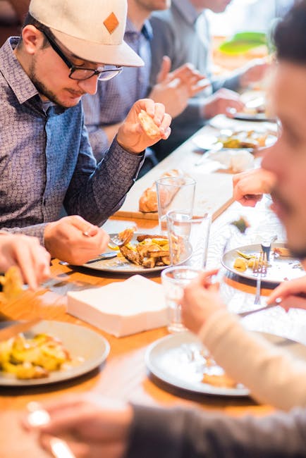 A group of adults enjoying a casual meal together, sharing friendship and good food.