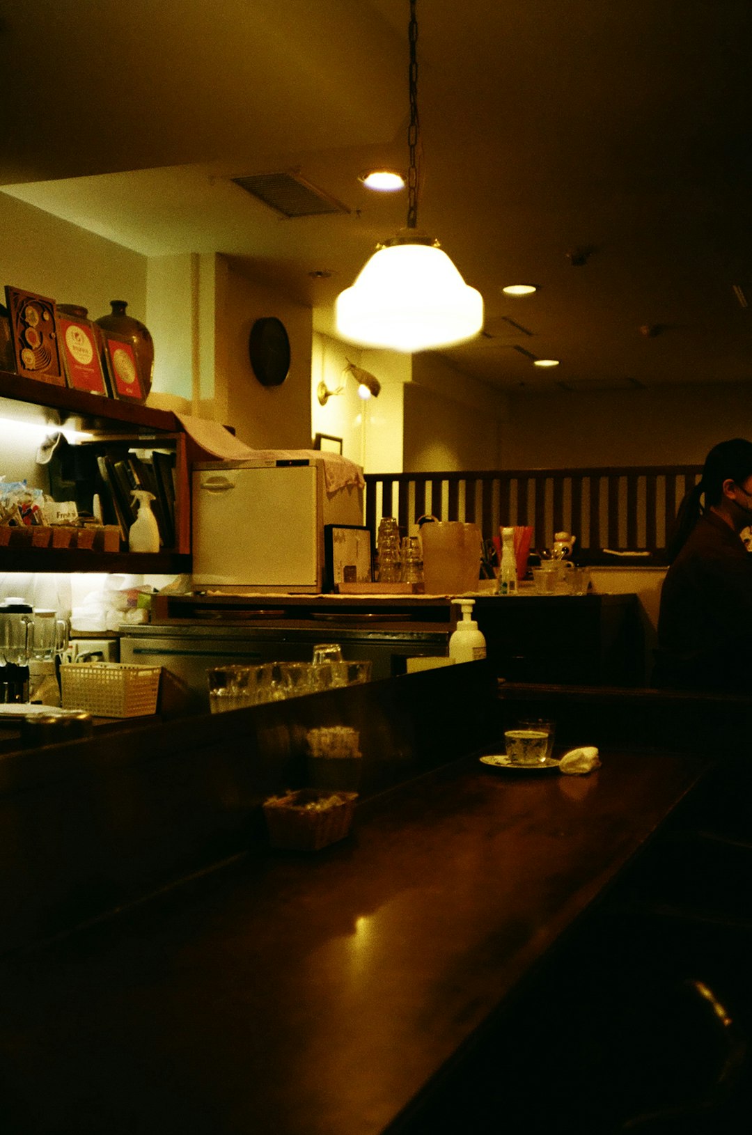 A man standing at a counter in a restaurant