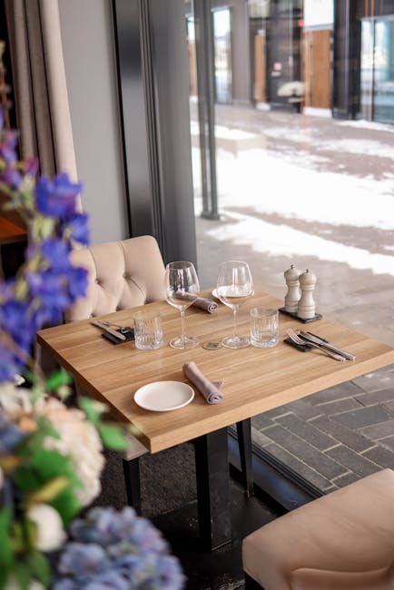 Stylish restaurant table setting with wine glasses, ideal for dining and hospitality themes.