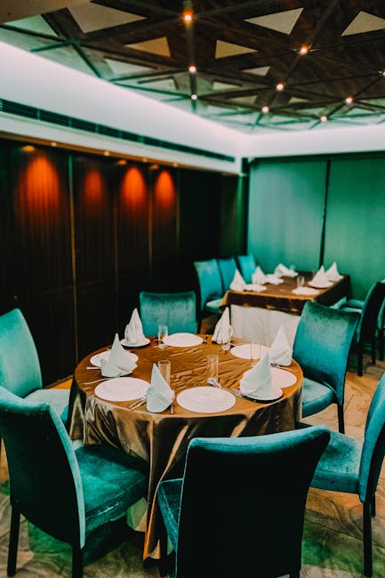 Luxurious dining setup in a modern restaurant featuring stylish furniture and ambient lighting.