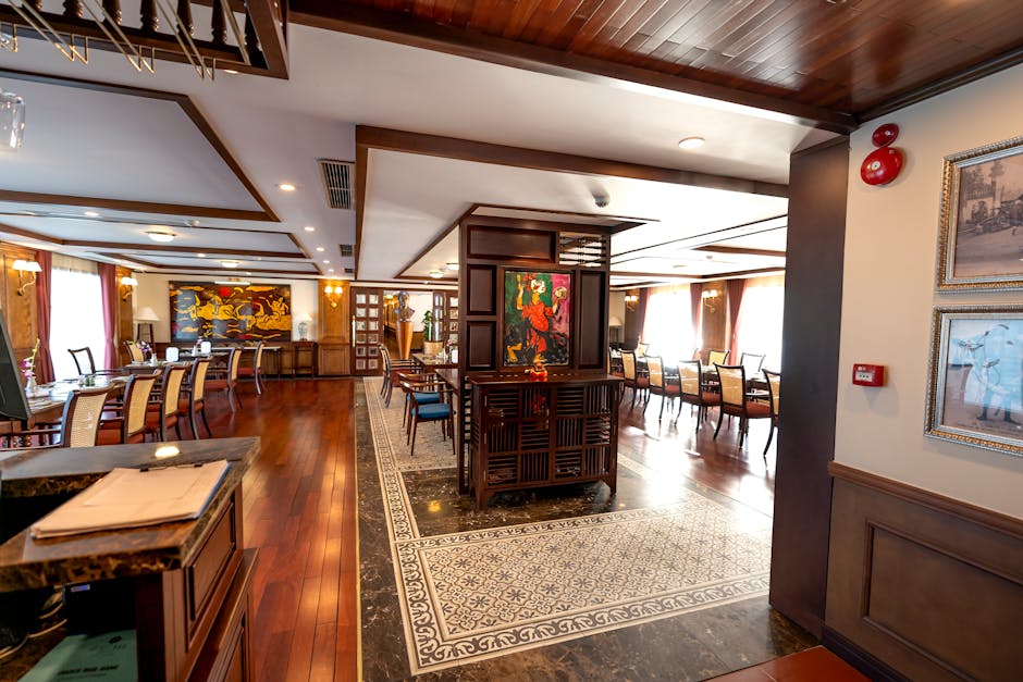 Luxurious hotel restaurant with elegant decor and wooden flooring.