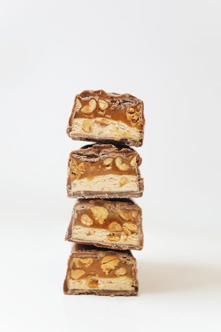 Delicious stack of sliced chocolate bars filled with nuts and caramel. Perfect snack or indulgence.
