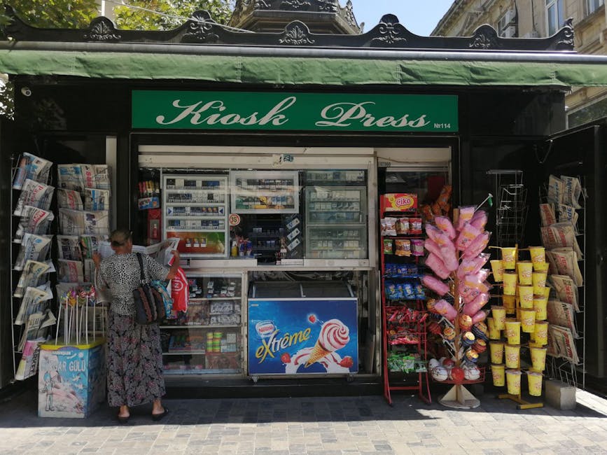 A woman shops at a kiosk selling newspapers and snacks in Azerbaijan.