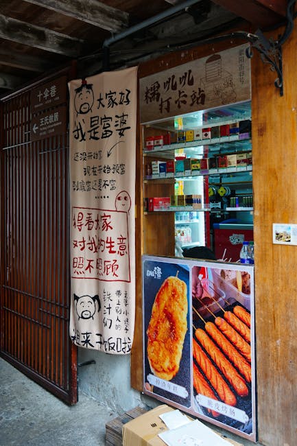 Street food vendor stall featuring snacks and colorful signage in an urban setting.