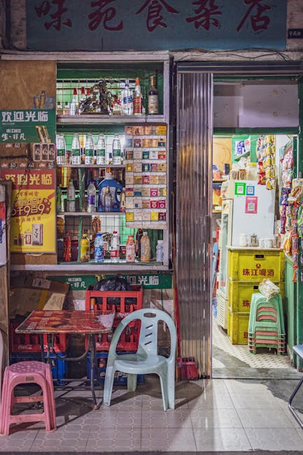 Colorful storefront in Guangzhou with chairs and stocked shelves under warm lighting.