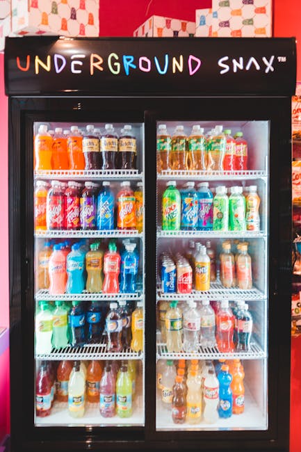Colorful assortment of drinks displayed in a chiller at Underground Snax store.