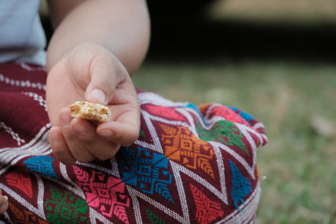 A small child holding a piece of food in their hand